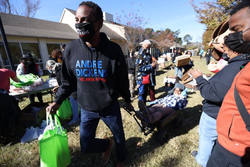 Mayoral candidate Andre Dickens had a little fun pulling a volunteer on a wagon during a Thanksgiving giveaway in southwest Atlanta. Dickens helped event organizers bring meals to the people's cars.
Saturday, November 20, 2021. Miguel Martinez for The Atlanta Journal-Constitution 