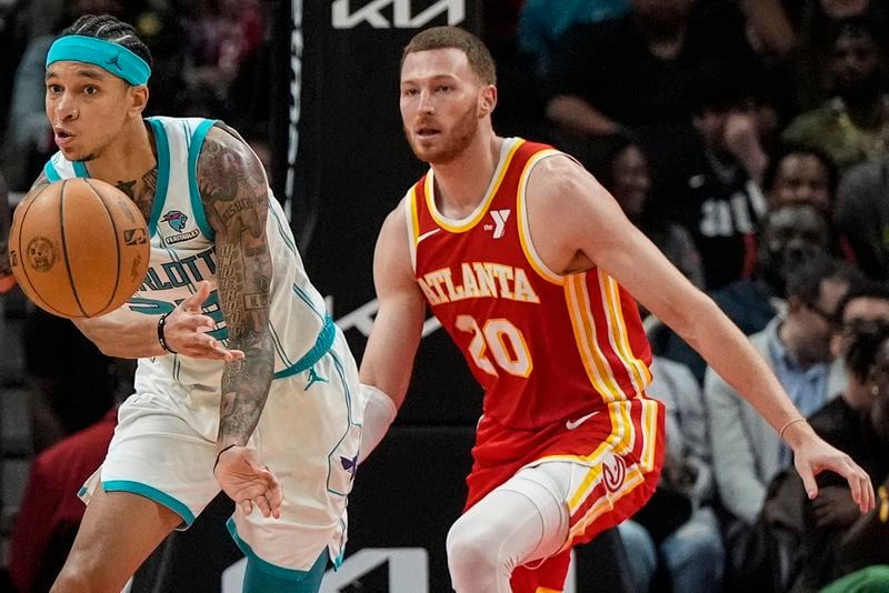 Charlotte Hornets guard Tre Mann (23) passes thge ball against Atlanta Hawks guard Dylan Windler (20) during the second half of an NBA basketball game, Wednesday, April 10, 2024, in Atlanta. (AP Photo/Mike Stewart)