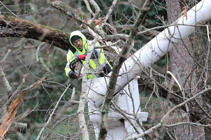 A worker from a tree company carries out the cleaning work where in the early hours the strong winds caused the fall of a tree splitting a house in two where a child of 5 years old died, his mother was taken to the hospital in Dekalb county.
Monday, January 3, 2022. Miguel Martinez for The Atlanta Journal-Constitution