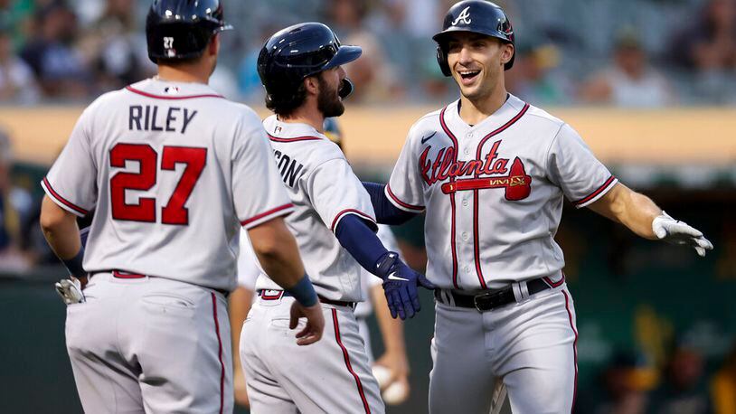 Atlanta Braves' Matt Olson, right, is congratulated by Dansby Swanson, center, and Austin Riley (27) after hitting a three-run home run against the Oakland Athletics during the third inning of a baseball game in Oakland, Calif., Tuesday, Sept. 6, 2022. (AP Photo/Jed Jacobsohn)