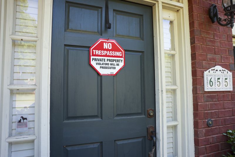 No trespassing signs are shown at the home at 655 Goldenwood Court, in the Broadlands subdivision, Monday, April 29, 2024, in Powder Springs, Ga. The home was previously squatted in by a man who was arrested last week. (Jason Getz / AJC)
