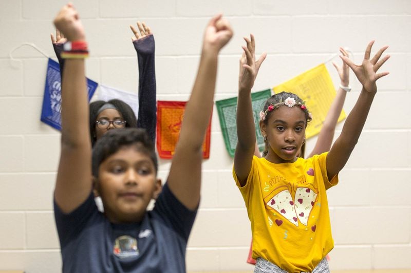 Berkeley Lake Elementary School fifth-grader Nahile Guzman (right) participates in a deep breathing exercise with a group of her peers at the Gwinnett County school. ALYSSA POINTER / ALYSSA.POINTER@AJC.COM