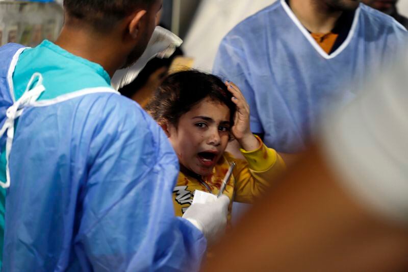 Palestinian medics treat a girl wounded in the Israeli bombardment of the Gaza Strip at the Kuwaiti Hospital in Rafah refugee camp, southern Gaza, Tuesday, May 7, 2024. (AP Photo/Ramez Habboub)