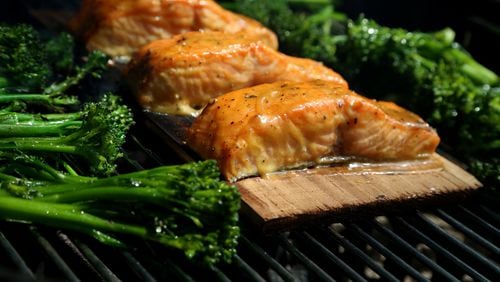 Cedar Plank Dijon Salmon with Broccolini on the grill on August 9, 2017. (Eric Seals/Detroit Free Press/TNS)