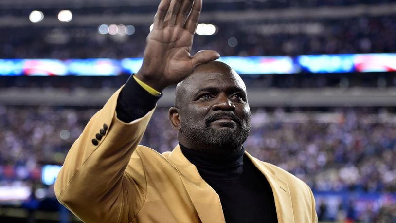 EAST RUTHERFORD, NJ - NOVEMBER 03: Former New York Giants player Lawrence Taylor waves to the crowd prior to their game against the Indianapolis Colts at MetLife Stadium on November 3, 2014 in East Rutherford, New Jersey. (Photo by Al Bello/Getty Images)