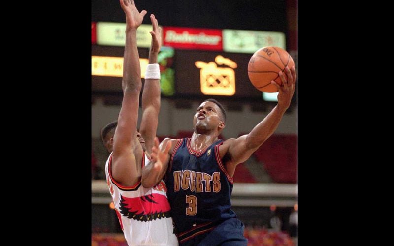 Dale Ellis (3) of the Denver Nuggets goes up against Ivano Newbill (28) of the Atlanta Hawks in 1996.