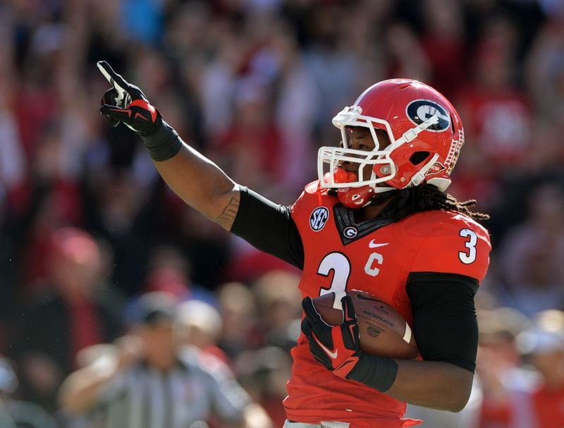 Georgia running back Todd Gurley (3) celebrates his first touchdown of the game against Vanderbilt at Sanford Stadium in Athens Saturday October 4, 2014. He will meet with teams at the combine and undergo medical tests. BRANT SANDERLIN / BSANDERLIN@AJC.COM