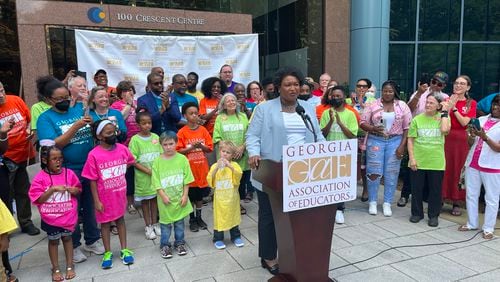 Stacey Abrams announces a plan to hike teacher pay outside the Georgia Association of Educators headquarters. Photo/Greg Bluestein