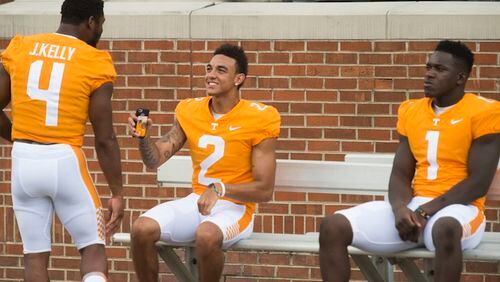 From left toright, running back John Kelly (4), quarterback Jarrett Guarantano (2) and defensive lineman Jonathan Kongbo (1) wait for group photographs during NCAA college football media day in Knoxville, Tenn., Sunday, Aug. 13, 2017. (Saul Young/Knoxville News Sentinel via AP)