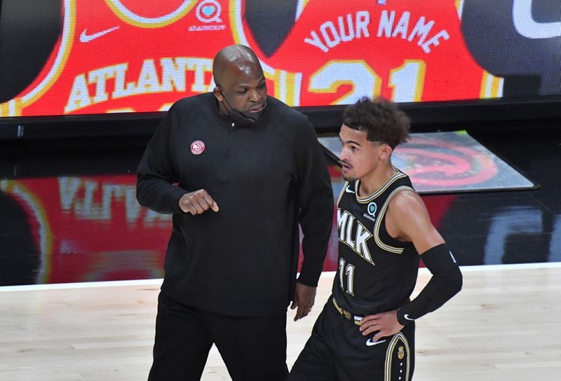 Hawks interim head coach Nate McMillan talks with guard Trae Young (11) during the first half Wednesday, May 5, 2021, at State Farm Arena in Atlanta. (Hyosub Shin / Hyosub.Shin@ajc.com)