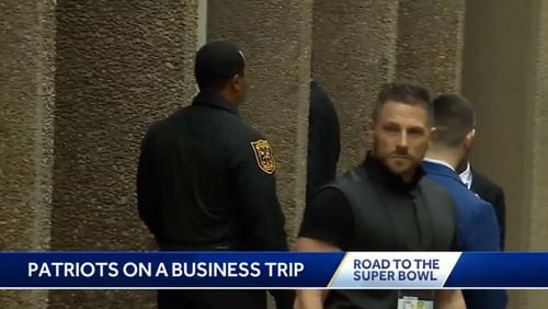 DeKalb police Captain Curtis Williams (left) was spotted on TV reports of the New England Patriots arriving in Atlanta in January.
