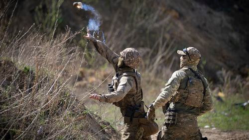 Members of the Siberian Battalion, which was formed mostly of volunteer Russian citizens, of the Ukrainian Armed Forces' International Legion, practice during military exercises, amid Russia's attack on Ukraine, at an undisclosed location in Kyiv region, Ukraine, Wednesday, Apr. 10, 2024. (AP Photo/Efrem Lukatsky)