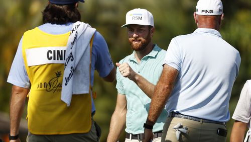 Chris Kirk smiles as he fist bumps the caddie of Stewart Cink on the 18th green during the final round of the Sony Open in Hawaii at the Waialae Country Club on January 17, 2021 in Honolulu, Hawaii. (Photo by Cliff Hawkins/Getty Images)