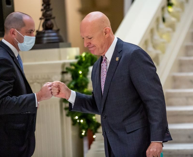  Attorney General Chris Carr (L) fist bumps  GBI Director Vic Reynolds during a press conference at the State Capital Tuesday, November 24, 2020. STEVE SCHAEFER / SPECIAL TO THE AJC 