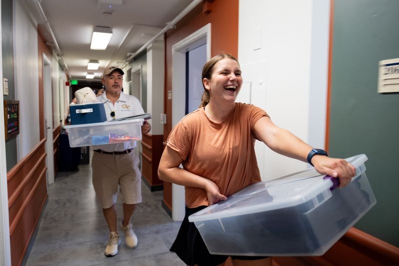 Lilly Sharp laughs as Georgia Tech President Ángel Cabrera helps her move in Sunday, Aug. 13, 2023.   (Ben Gray / Ben@BenGray.com)