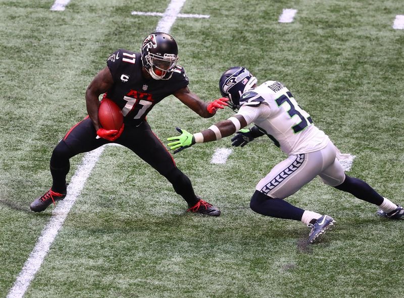 Falcons wide receiver Julio Jones makes a first-down catch against Seattle Seahawks strong safety Jamal Adams during the second half Sunday, Sept. 13, 2020, at Mercedes-Benz Stadium in Atlanta. (Curtis Compton / Curtis.Compton@ajc.com)