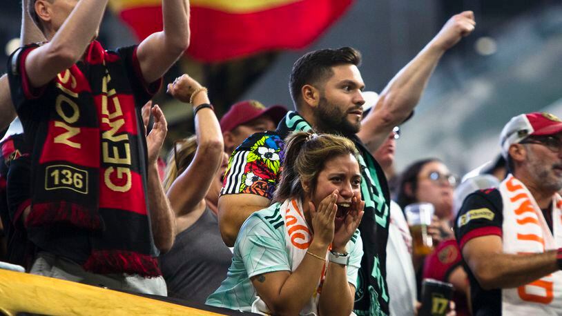 An Atlanta United fan cheers during an MLS game against the Philadelphia Union on Sept. 17 at Mercedes-Benz Stadium. (CHRISTINA MATACOTTA / FOR THE ATLANTA JOURNAL-CONSTITUTION)