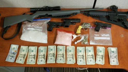 Over six ounces of methamphetamine, four handguns, two rifles and a sawed-off shotgun were found in the safe where a 22-year-old was hiding before his arrest.