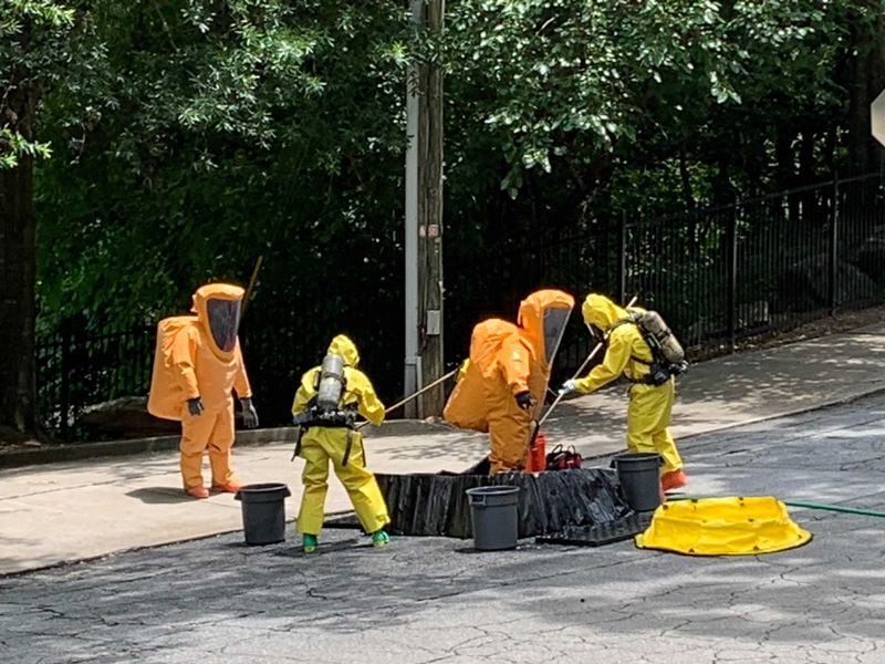 A decontamination team is scrubbed down after exiting the sewer treatment facility Thursday afternoon.