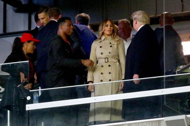When Republican U.S. Senate candidate Herschel Walker, shown with former first lady Melania Trump and ex-President Donald Trump at the World Series in Atlanta, spoke at a recent Cobb County GOP event, one of the people there said he only talked about his football career and how he met Donald Trump. “He didn’t really say what he stood for, and then he zipped out the back door," said Paul Brower, a GOP volunteer. "I was stunned.” Curtis Compton / curtis.compton@ajc.com