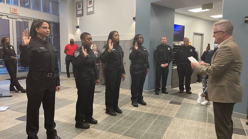 Alpharetta Police Chief John Robison recently swore in four 911 Communications Officers following their successful completion of training. (Courtesy City of Alpharetta)