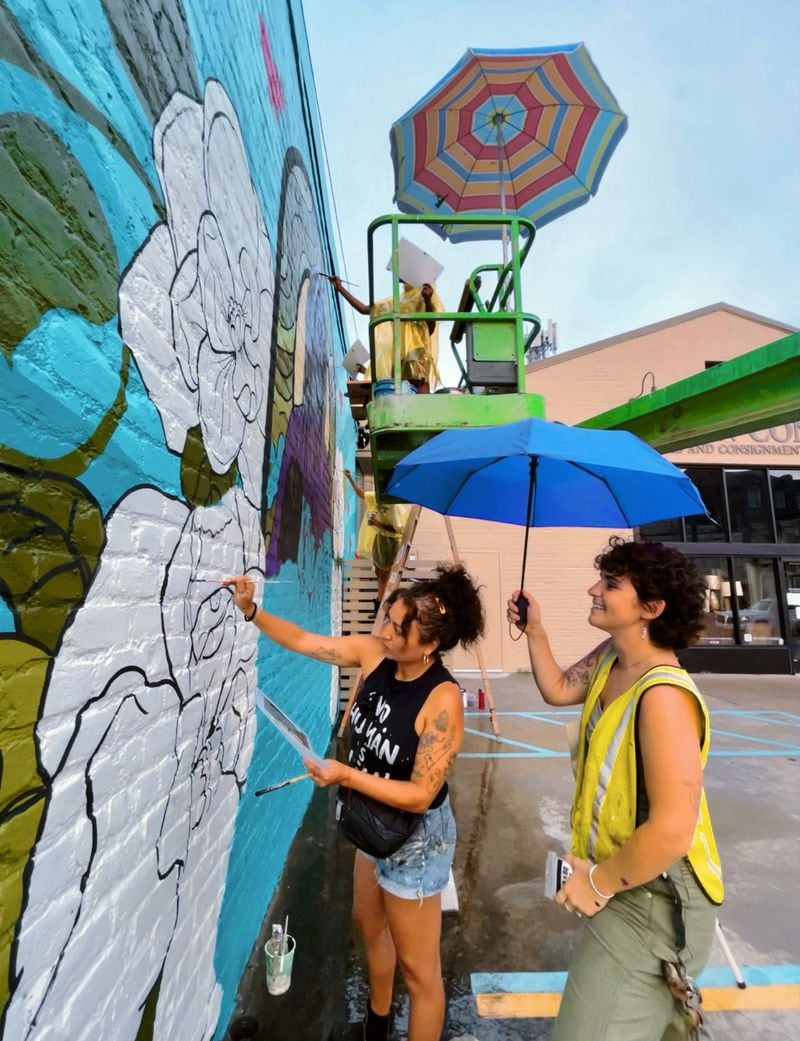 Living Walls executive director Monica Campana (left) and director of productions Kristen Consuegra paint a mural in New Orleans last month as part of the Adult Swim Mural Project. 
Courtesy of Tatiana Bell/ Living Walls