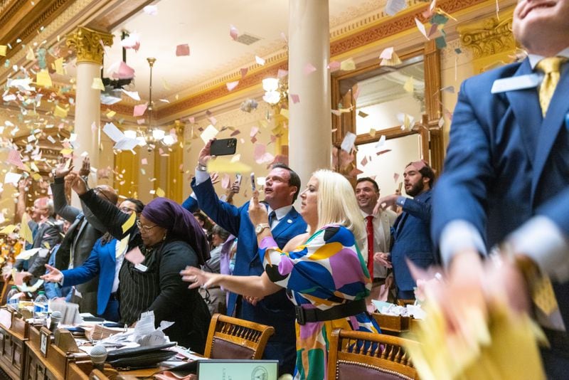 State senators throw papers in the air to celebrate the end of the legislative session at the Senate in Atlanta on Sine Die, Wednesday, March 29, 2023. (Arvin Temkar / arvin.temkar@ajc.com)