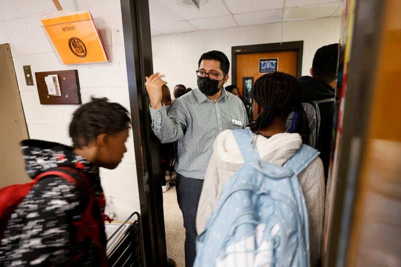 At the end of the class, Daniel Garcia, a social studies teacher at Shiloh Middle School in Gwinnett County, helps the students to move to the next class on Tuesday, Oct. 18, 2022. (Miguel Martinez / miguel.martinezjimenez@ajc.com)