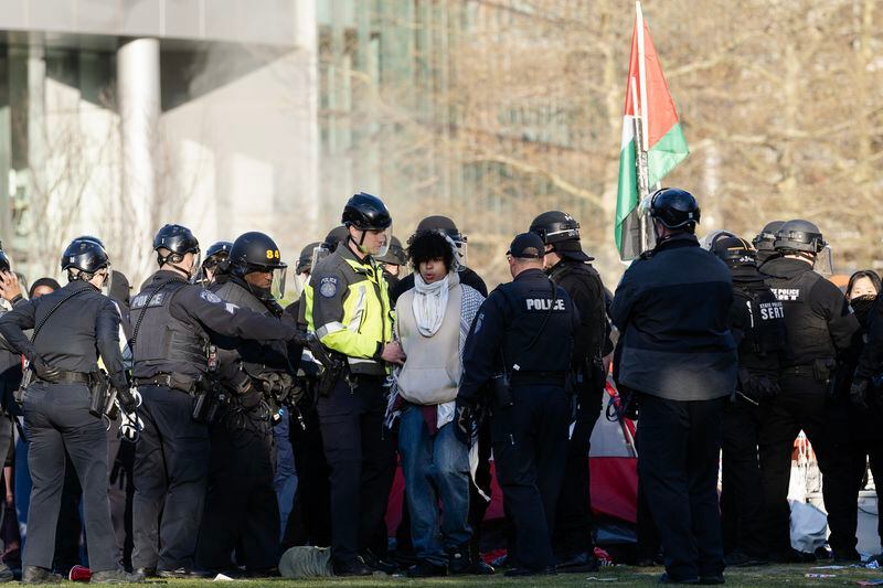 
                        A protester is arrested by law enforcement officials as they clear the encampment of pro-Palestinian protesters from the campus at Northeastern University in Boston, Mass., on Saturday, April 27, 2024. Some colleges that initiated police crackdowns on pro-Palestinian protests have since taken a different tack. Others have defended the move. Hundreds have been arrested. (Sophie Park/The New York Times)
                      