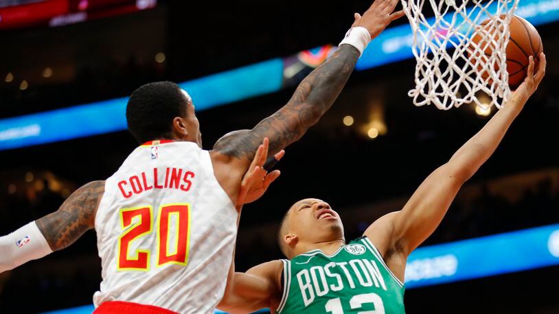 Celtics forward Grant Williams (12) goes up for the shot as Hawks forward John Collins (20) defends in the first half of an NBA basketball game on Monday, Feb. 3, 2020, in Atlanta. (AP Photo/Todd Kirkland)