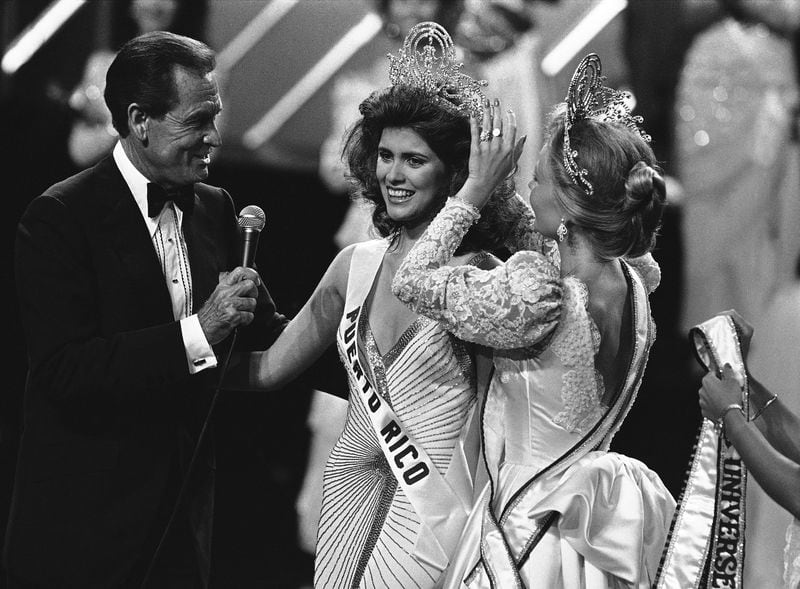 Host Bob Barker watches as Miss Universe of 1985 Deborah Carthy-Deu, of San Juan,  is crowned  in Miami on July 15, 1985. (AP Photo/Raul de Molina)
