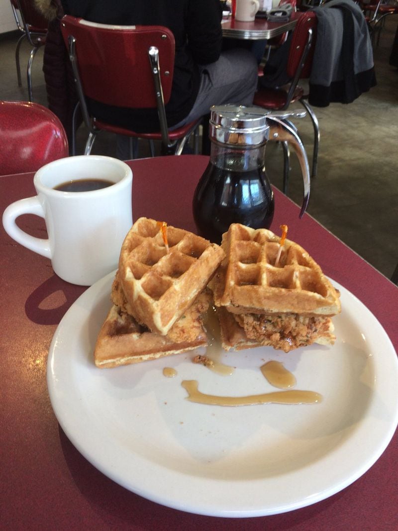 Atlanta Breakfast Club’s fried chicken and waffle is served like a sandwich, with a drizzle of syrup. CONTRIBUTED BY WENDELL BROCK