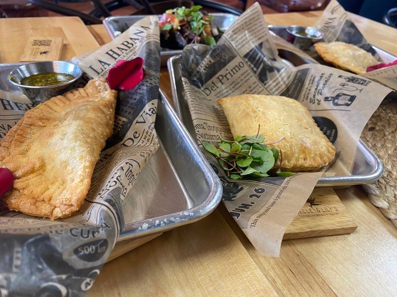 An assortment of fried pocket entrees from Belle & Lily's include (from left to right) beef empanada, Jamaican patty, and chicken empanada.  Ligaya Figueres/ligaya.figueras@ajc.com
