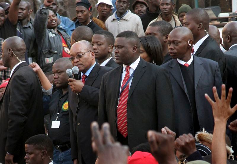 FILE - Then South African deputy president, Jacob Zuma, holding microphones, addresses supporters after being found not guilty of rape in Johannesburg, Monday May 8, 2006. For the first time since 1994, the ruling African National Congress (ANC) might receive less than 50% of votes after Zuma stepped down in disgrace in 2018 amid a swirl of corruption allegations and has given his support to the newly-formed UMkhonto WeSiizwe political party. (AP Photo/Denis Farrell, File)