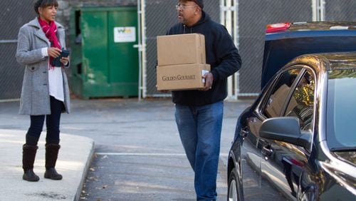 Volunteer Rodney Cheek helps to load cars with box dinners for Meals On Wheels in 2018. STEVE SCHAEFER / SPECIAL TO THE AJC