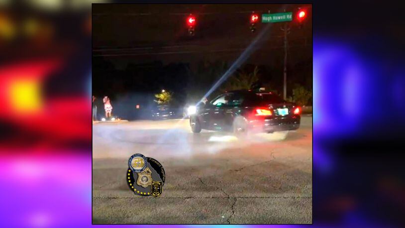 A street racer burns out during an intersection takeover in DeKalb County.