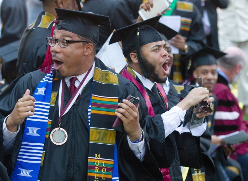 Graduates react after hearing billionaire, Robert F. Smith is paying all student debt for the class of 2019 during the  Morehouse College graduation ceremony in Atlanta on Sunday, May 19, 2019. STEVE SCHAEFER / SPECIAL TO THE AJC