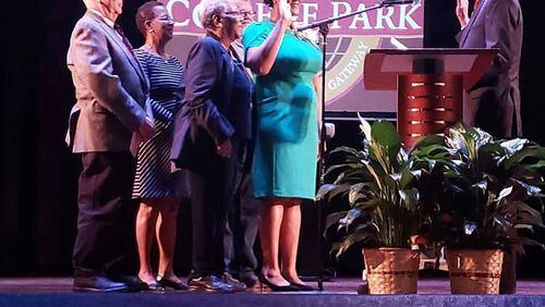 College Park Mayor-elect Bianca Motley Broom stands with her family during her swearing in ceremony Monday night. CONTRIBUTED