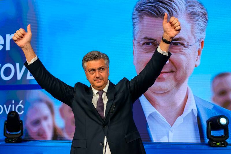 Prime Minister incumbent Andrej Plenkovic waves after claiming victory in a parliamentary election in Zagreb, Croatia, Thursday, April 18, 2024. Croatia's governing conservatives convincingly won a highly contested parliamentary election Wednesday, but will still need support from far-right groups to stay in power, according to the official vote count. The election followed a campaign that centered on a bitter rivalry between the country's president and prime minister. (AP Photo/Darko Vojinovic)