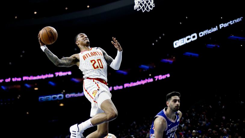 Atlanta's John Collins goes up for a dunk against Furkan Korkmaz of the Sixers during the first half of Monday's game in Philadelphia. (AP Photo/Matt Slocum)