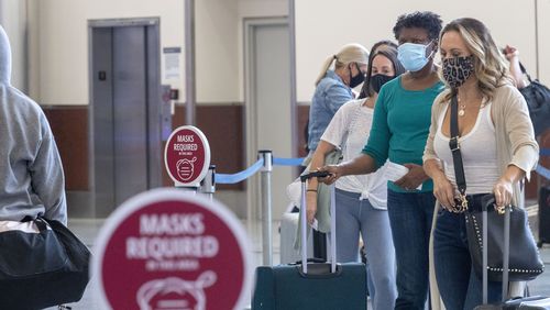 09/04/2020 -Atlanta, Georgia - Delta Air Lines customers wear masks as they wait to be served at the ticker counter in the domestic terminal at Hartsfield-Jackson Atlanta International Airport, Friday, September 4, 2020. (Alyssa Pointer / Alyssa.Pointer@ajc.com)
