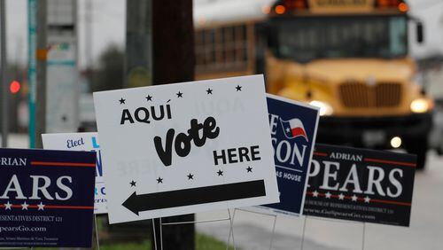 FILE - In this March 2, 2018, file photo, signs mark a polling site as early voting begins, in San Antonio. Democrats in Texas are early voting in bigger numbers ahead of the nation's first primary elections of the 2018 midterms. Turnout figures released Thursday, Feb. 22, 2018, shows more Democrats casting ballots than Republicans since early voting began this week in the nation's biggest conservative state. (AP Photo/Eric Gay, File)