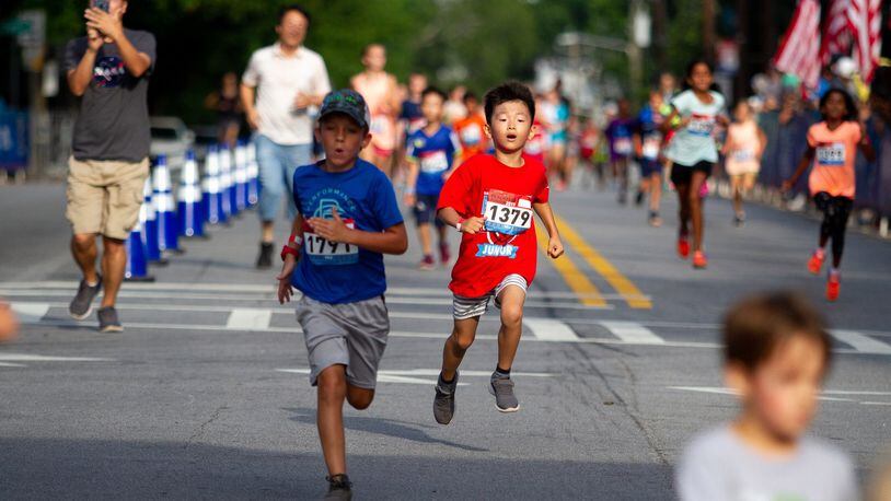 Runners sprint for the finish line during the Anthem Peachtree Junior race on 10th Street Wednesday, July 3, 2019. STEVE SCHAEFER / SPECIAL TO THE AJC