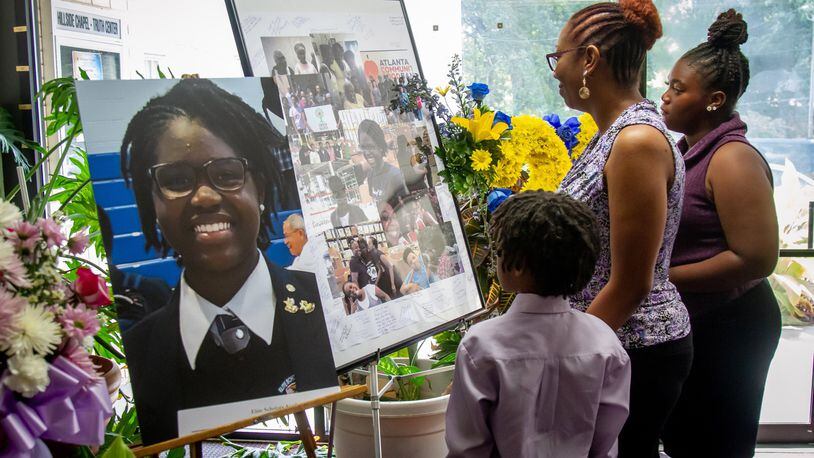People look over the flowers and photographs before the start of funeral services Saturday for Imani Bell at the Hillside Chapel & Truth Center in Atlanta August 24, 2019. (Photo: STEVE SCHAEFER / SPECIAL TO THE AJC)