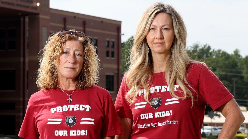 081522 Cumming, Ga.: Alison Hair, left, and Cindy Martin stand in front of the Forsyth County Schools building Monday, August 15, 2022, in Cumming, Ga. Cindy Martin and Alison Hair are plaintiffs in a federal lawsuit that contends their constitutional free speech rights were violated when the Forsyth school board refused to allow them to read aloud from school library books during public meetings. Hair and Martin wore shirts that read, “Protect Our Kids! Education Not Indoctrination.” (Jason Getz / Jason.Getz@ajc.com)