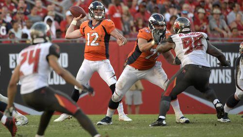 Denver Broncos quarterback Paxton Lynch (12) throws a pass as offensive guard Michael Schofield (79) blocks Tampa Bay Buccaneers defensive tackle Clinton McDonald (98) during the second half of an NFL football game in Tampa, Fla., Sunday, Oct. 2, 2016. The Broncos won 27-7. (AP Photo/Phelan M. Ebenhack)