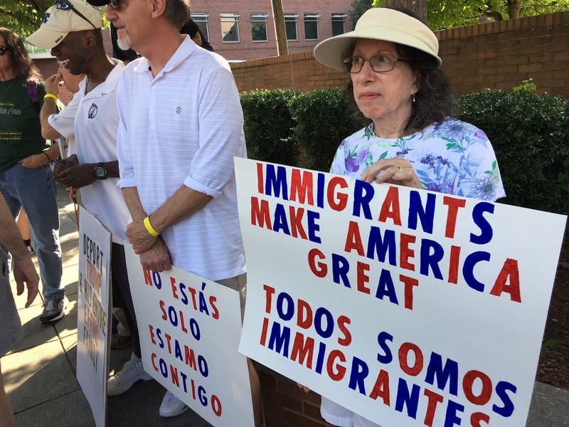 Sally Page and her husband, Rick, carry signs during the Families Belong Together rally in Atlanta on Saturday, June 30, 2018. is Sally Page, also of Atlanta. The local event and similar rallies around the nation on Saturday were to protest U.S. immigration policies that separate children from their parents. (Photo: Danny Robbins/drobbins@ajc.com)