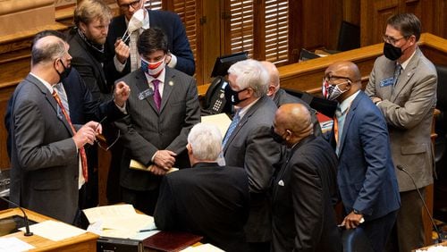 210331-Atlanta-Sen. Matt Brass (R-Newnan), center, is in the middle of a huddle about hemp farming during the final day of the 2021 Legislative session Wednesday, March 31, 2021. Ben Gray for the Atlanta Journal-Constitution