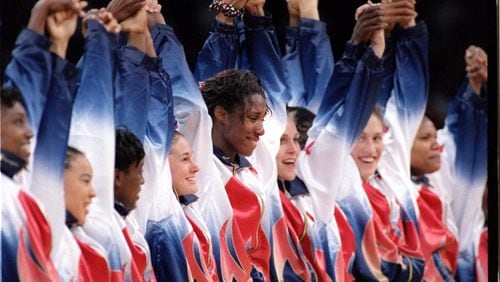 The U.S. women’s basketball team joins hands in celebration after winning the gold medal Sunday, August 4, 1996 in Atlanta. (AJC file photo/David Tulis)