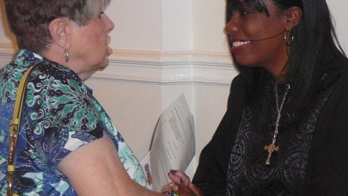 Rev. Claudette Farmer greets church member Rosemary Strickland after a service at the First United Methodist Church of Marietta. Farmer, who is the only minority on the staff, left the corporate world to go into the ministry.